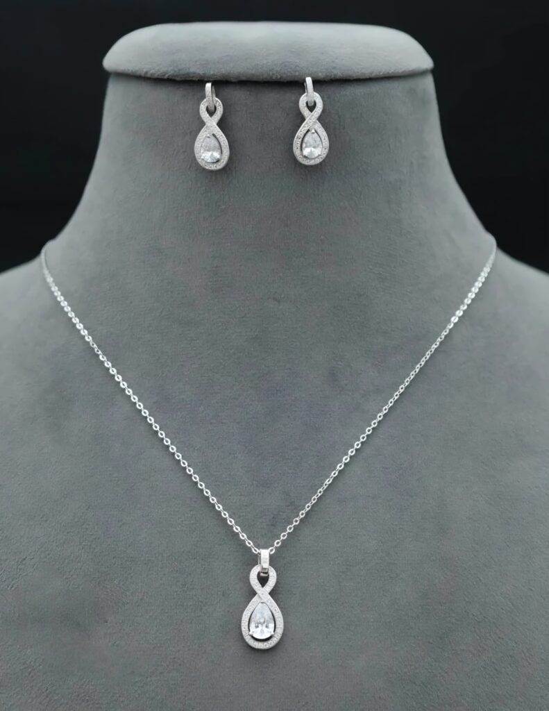 This stunning 925 sterling silver pendant and earring set features a teardrop design, symbolizing infinite and eternal love. Adorned with high-quality cubic zirconia stones,